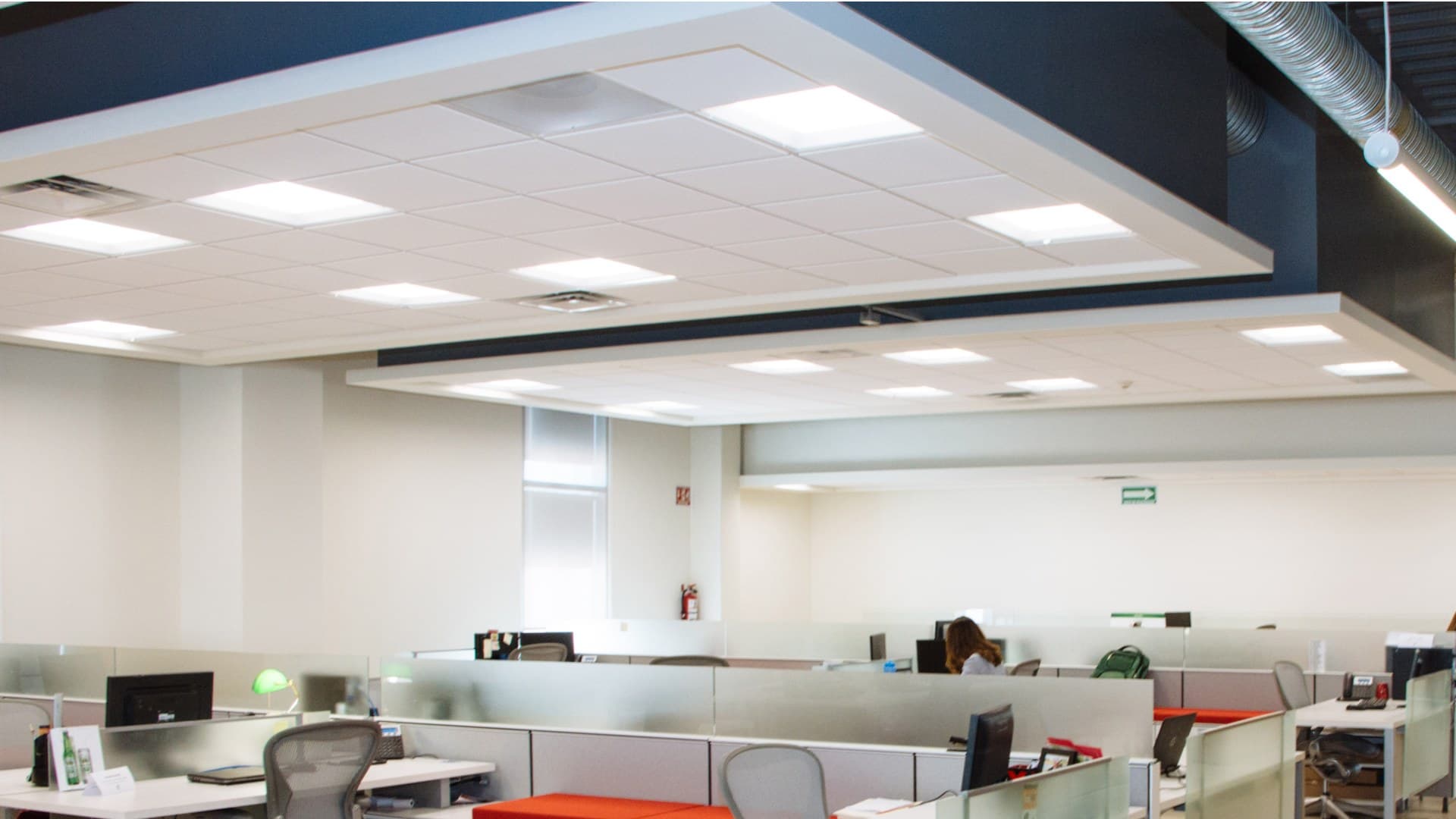 Open office interior with panel lights and ceiling lighting.