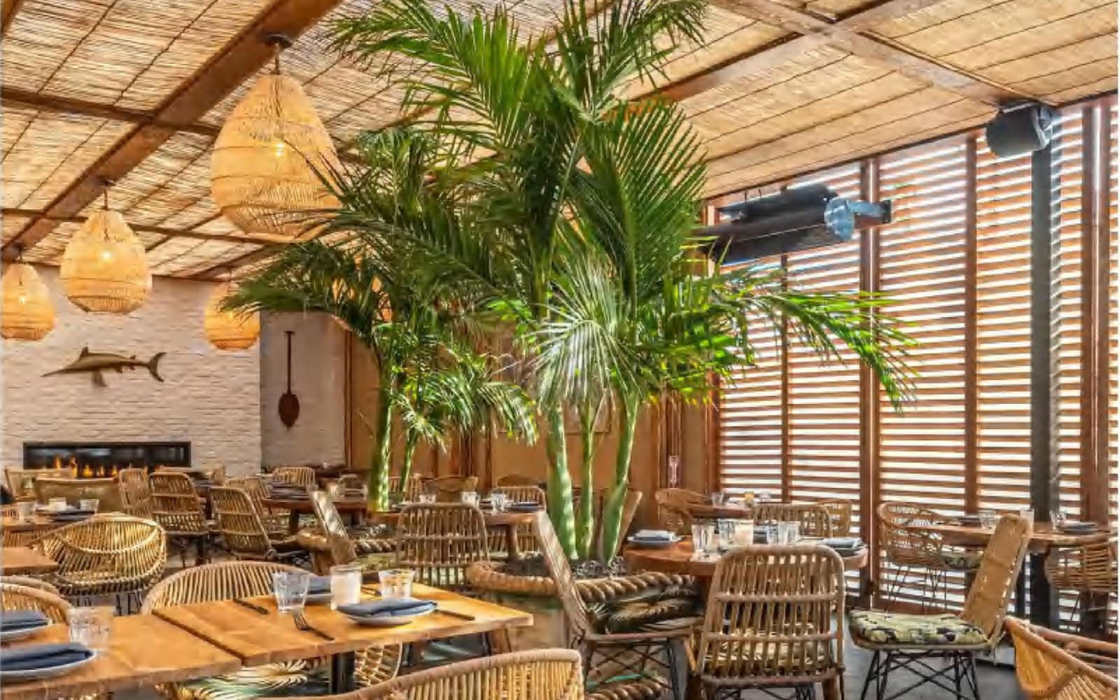 Cropped warm restaurant interior with wooden decorative lighting.