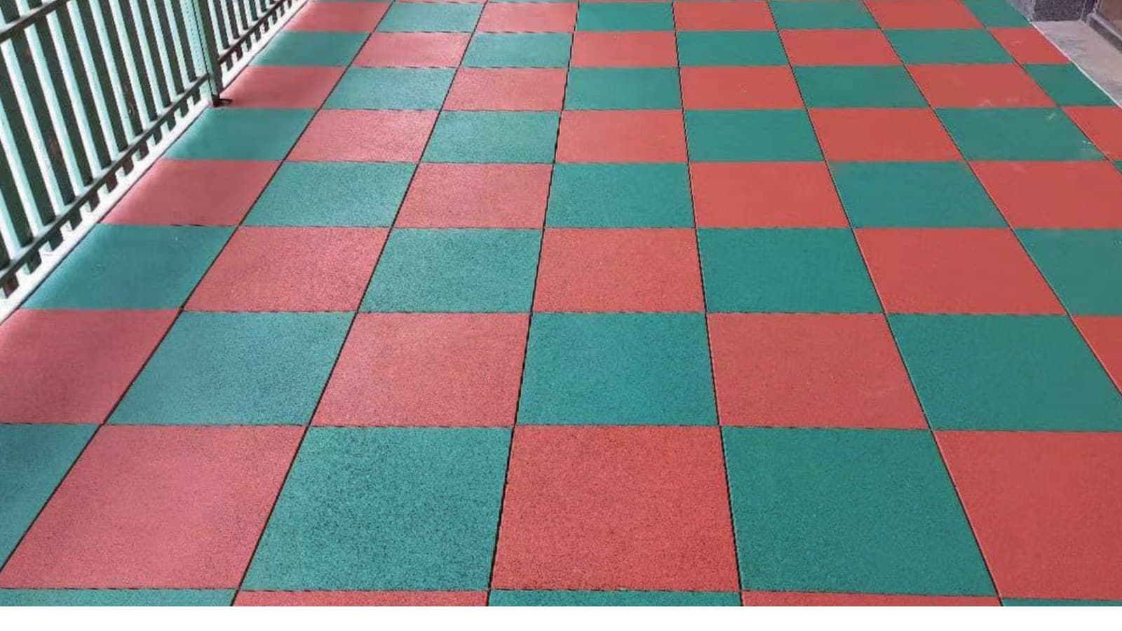 Outdoor rubber tile surface reference with red and green rubber flooring squares.
