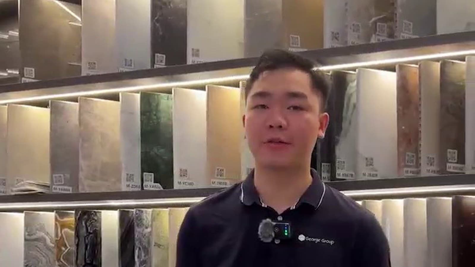 George Group team member presenting material samples in a building material showroom.