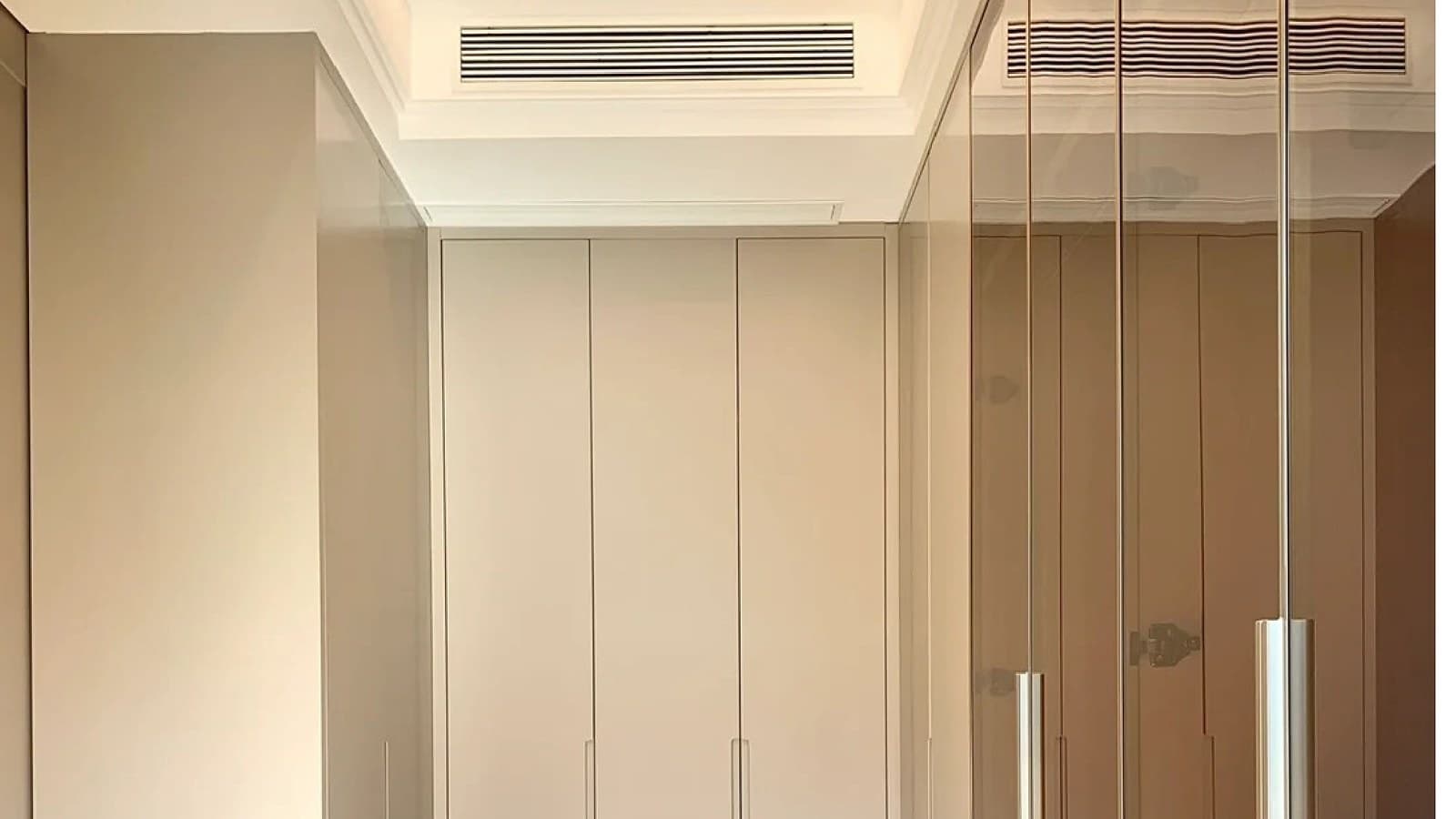 Built-in wardrobe and walk-in closet interior with closed storage doors