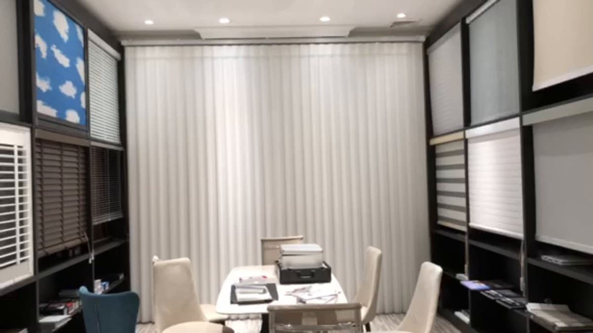Curtain fabrics reviewed in a George showroom selection setting